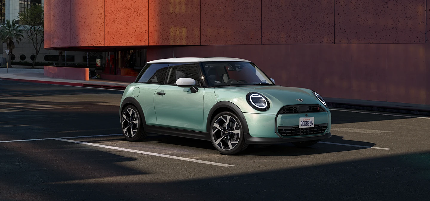 Side front view of the MINI Cooper in Ocean Wave Green and White Roof.