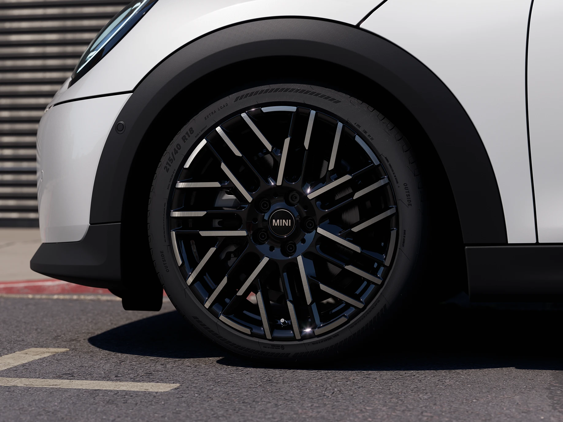 Close shot of the MINI Cooper 5-Door in Nanuq White with Night Flash Spoke 2-tone rims.