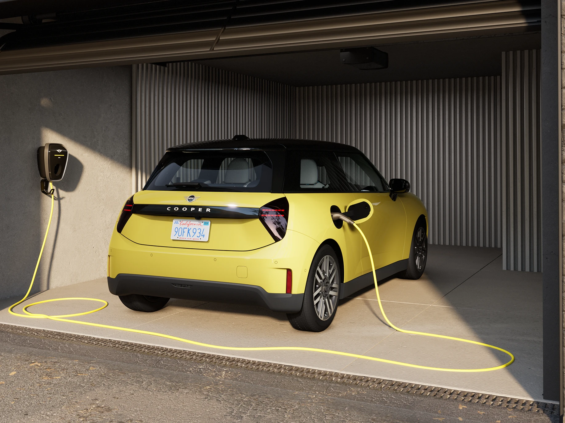Rear view of an all-electric MINI Cooper in Sunnyside Yellow while charging in a garage. 