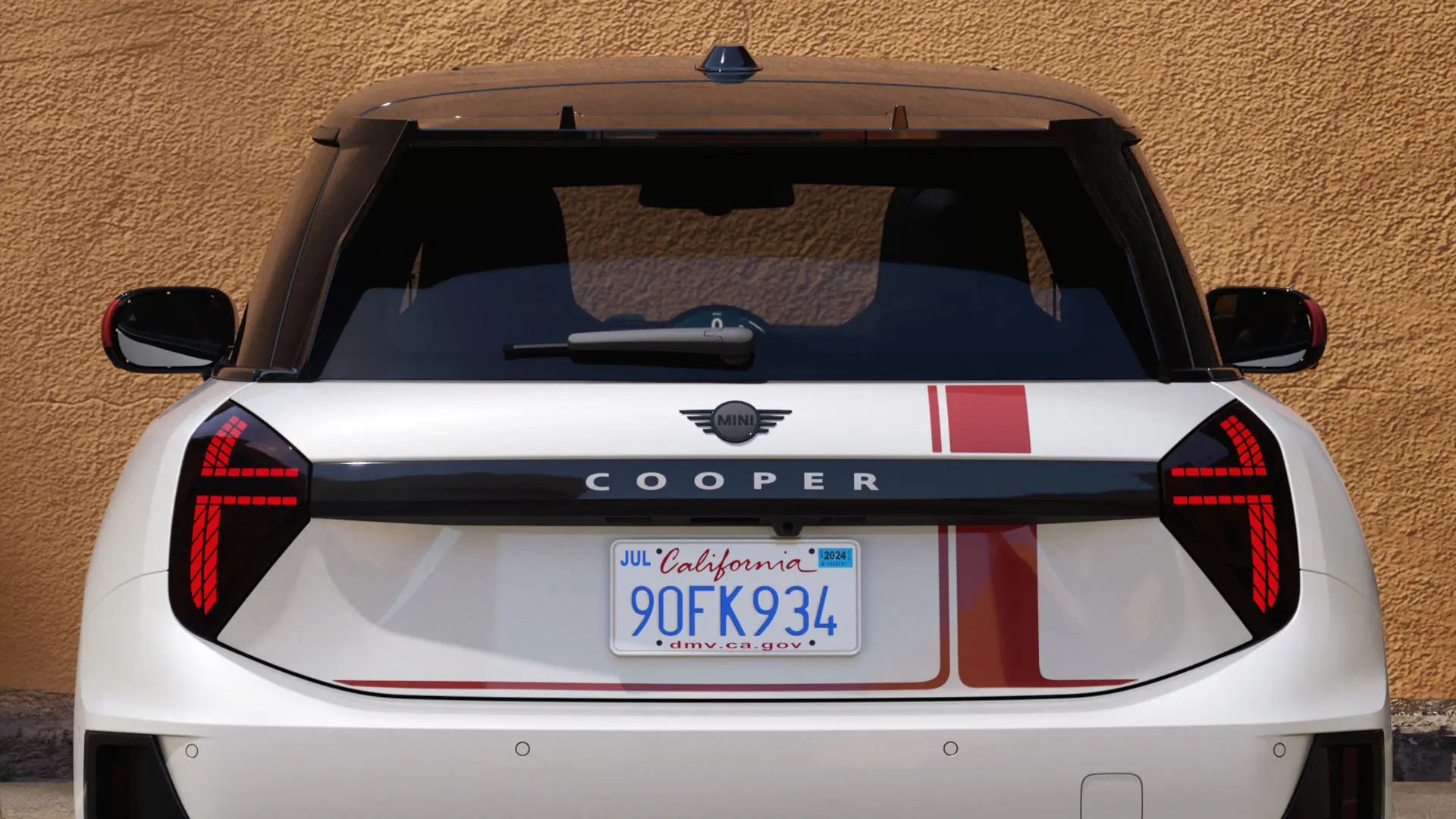 MINI Cooper three-door with MINI John Cooper Works decals in Chili Red – rear view. 
