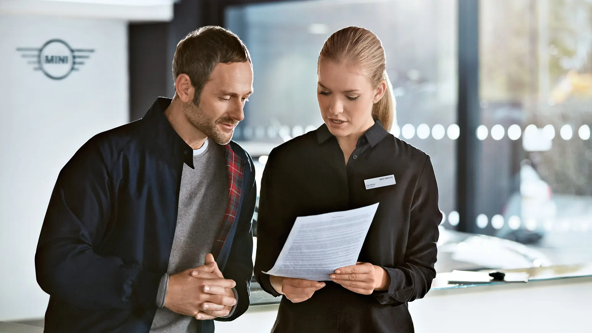 MINI Service consultant advising customer about service plans at MINI Centre.