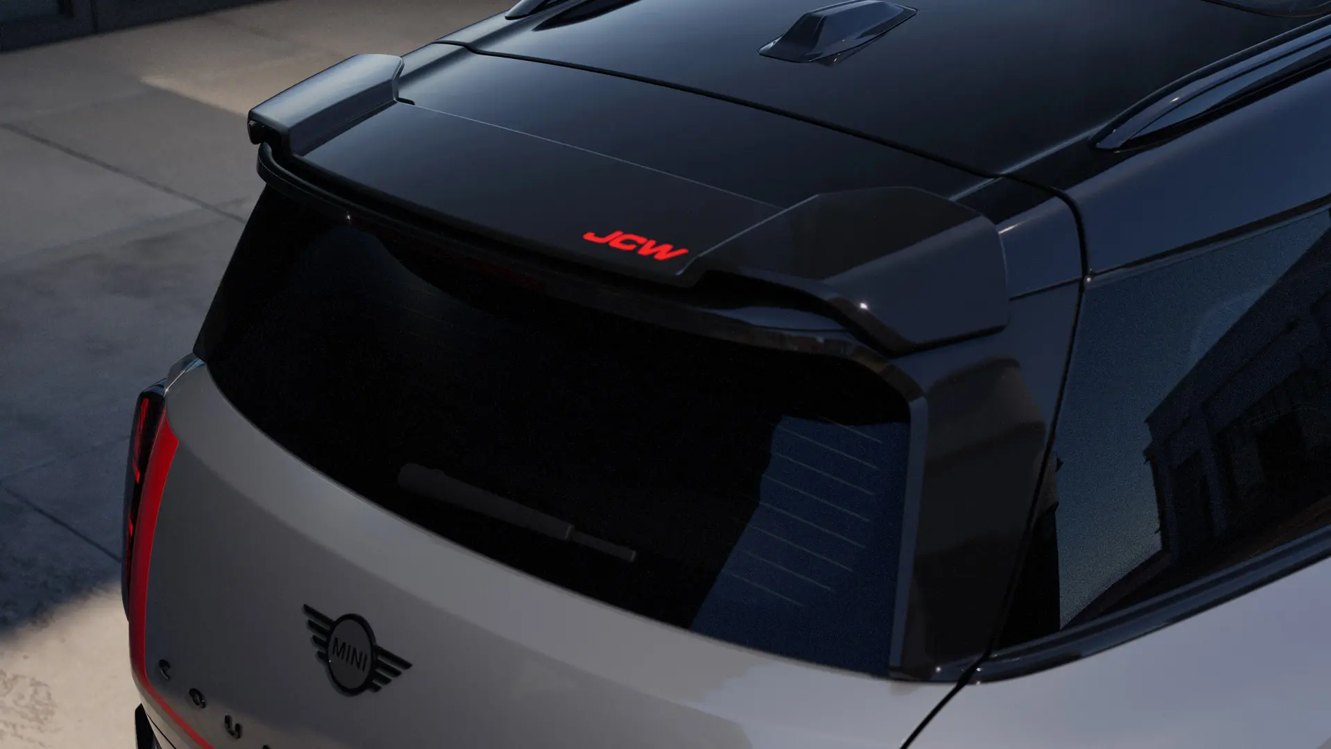 MINI John Cooper Works roof edge spoiler attachment with John Cooper Works Chili Red accent.