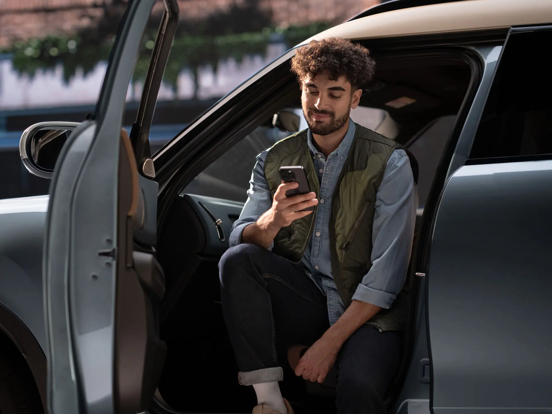 A man booking a service appointment using his mobile phone.